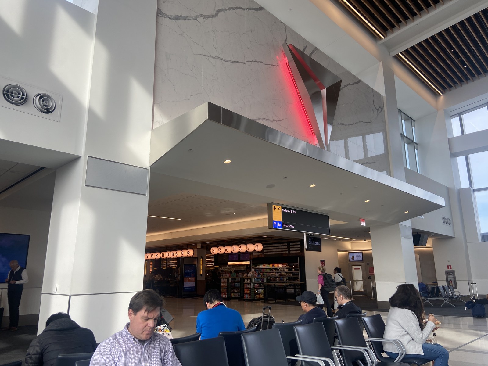 Interior photograph of the Terminal C concourse at Delta gates 70 to 79 in May 2024, with the corridor, seating, and gate signage