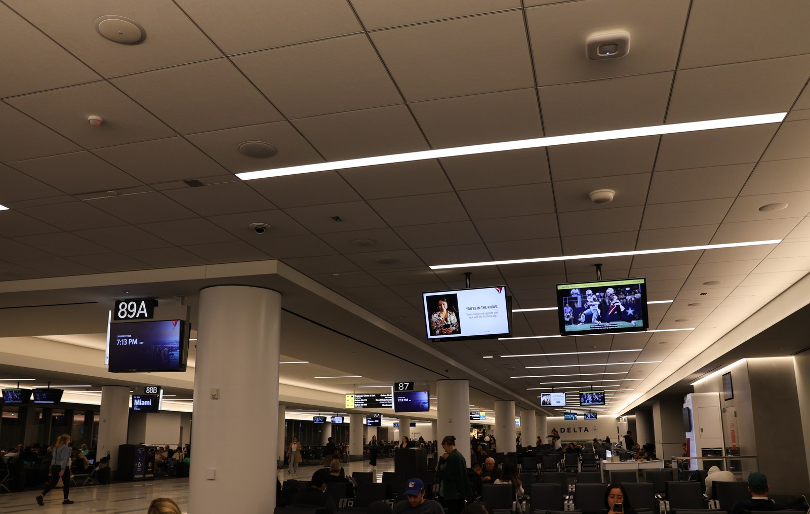 Interior photograph of the gate 89A hold room in Terminal C in October 2023, with seating, windows onto the apron, and gate signage